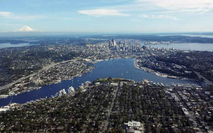 A y-shaped body of water surrounded by a city with skyscrapers at one end.